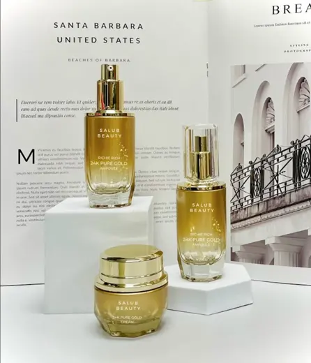Bộ chai serum và hũ kem thủy tinh màu vàng ánh kim in logo thương hiệu
